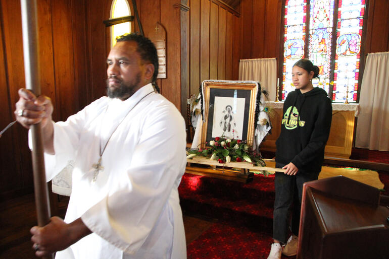 Adam Hape carries the processional cross into St Paul's Rangiaowhia followed by the Meri Tapu icon flanked by Latoya Siumaana.