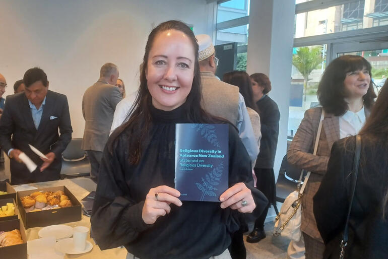 Race Relations Commissioner Dr Melissa Derby holds the 2026 Statement on Religious Diversity during an Auckland Interfaith launch event.