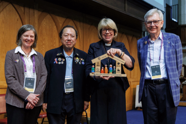 Dr Kim Barker, Canon Andrew Khoo, Archbishop Sarah Mullally and Garth Blake show a model of Safe Church at ACC-19. Photo: Neil Turner